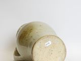 a close up of a vase on a white surface