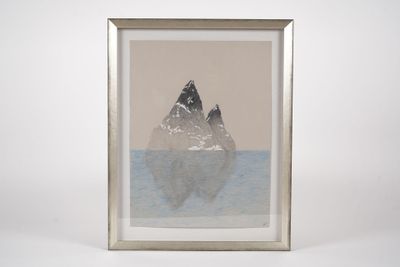an image of a picture of two mountains in a frame on a table