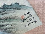 a piece of paper with a painting on it on a table