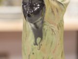 a statue of a woman that is sitting on a table