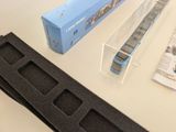 a plastic box with a watch in it next to a plastic box with a watch inside of it