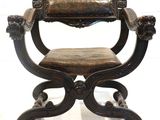 a wooden chair with a leather seat on a white background