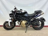 a picture of a black motorcycle parked in a garage