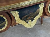 a large wooden table with a painting on it