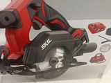 a corded circular saw on a table with a box