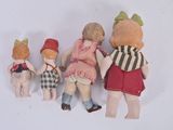 five little dolls that are lined up together on a white surface