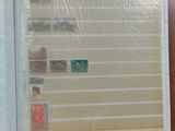 an open book with stamps on it sitting on a table