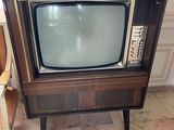 a small television sitting on a small table in a room