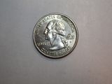 a close up of a coin on a table with a white background