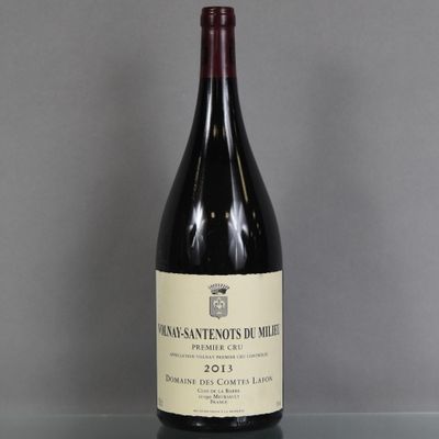 a bottle of wine sitting on a glass table