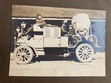 an old photo of a man sitting in an old car