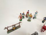 many figurines of different people on a white surface