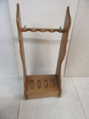 a small wooden rack with four pairs of shoes on it