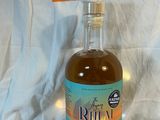 a bottle of liquor sitting on a table with a price tag