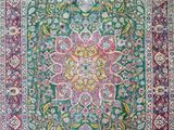 a green and red rug with a floral design on it