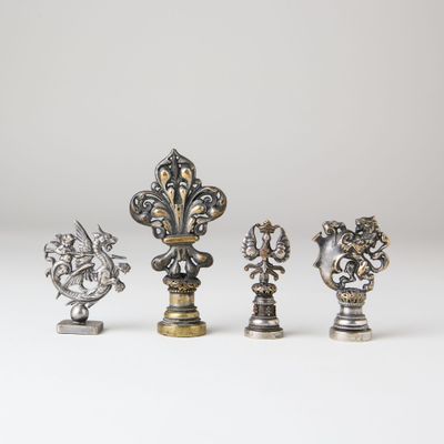 a set of four silver and gold metal figurines