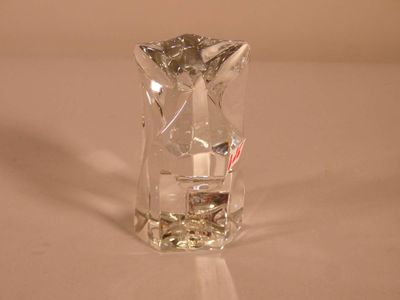 a clear glass vase with a candle inside of it