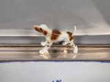 a toy dog that is standing on a shelf