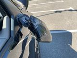 the side view mirror of a car with a broken mirror on it ' s side