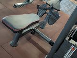 an image of a gym room with a bench, weights, and other equipment