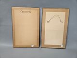 two framed pictures of a pair of scissors on a gray background