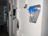 a long hallway with a bunch of pipes on the wall