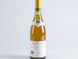 a close up of a bottle of wine on a white surface