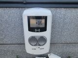 a parking meter on the ground next to a window