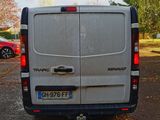 a white van parked in a parking lot with other cars in the background