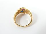 an image of a gold ring with a blue and pink stone