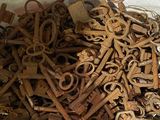 a pile of old rusty keys on a table