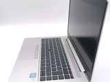 a laptop computer that is sitting on a white surface