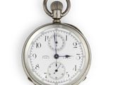 a close up of a silver pocket watch on a white background