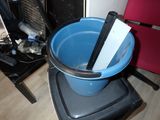 a blue bucket that has a pair of scissors in it