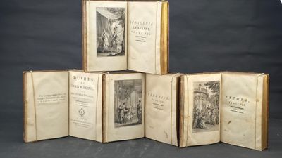 several old books are stacked on top of each other on a table