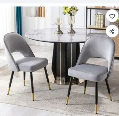 two chairs that are next to a table in a room