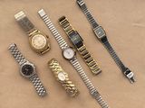a lot of watches that are sitting on a table