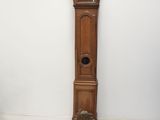 a grandfather clock sitting next to a tall wooden grandfather clock