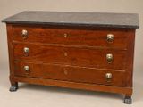 an antique chest of drawers with marble top on casteors