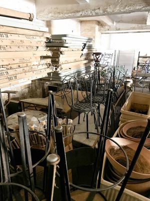 many chairs and tables in a room with a lot of pots and pans