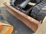 an image of a close up of a tractor with a plow attachment