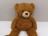 a brown teddy bear that is sitting on a table