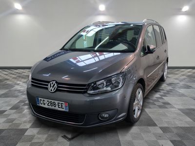 the volkswagen b - cross is parked on a checkered floor in a garage