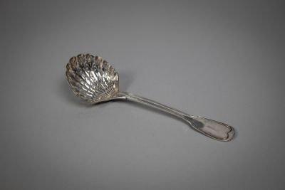 a close up of a spoon on a table with a gray background