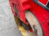a close up of a red vehicle with a yellow tire