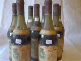 several bottles of wine are lined up on a table