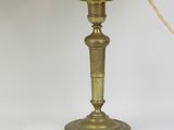 brass plated table lamp with a cream shade on a white background