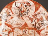 a decorative plate with oriental designs on it on a table