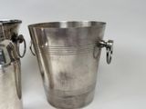 two metal buckets that are sitting next to each other