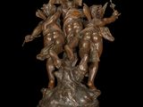 bronze statue of three cherensils on a marble base